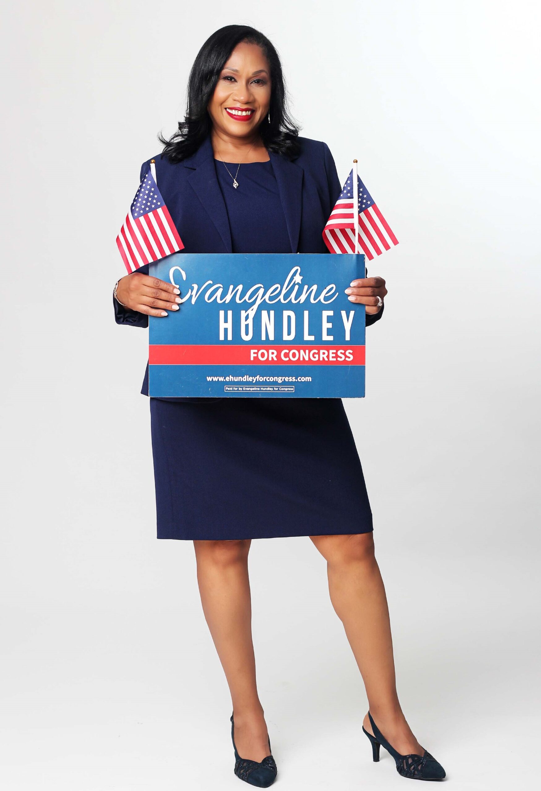 Evangeline Hundley holding a campaign sign that says Evangeline Hundley for Congress